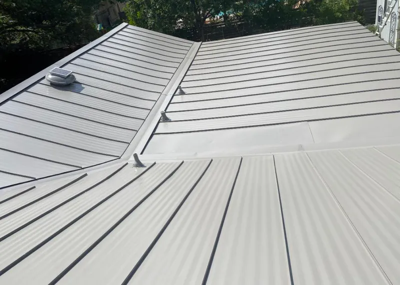 Solar attic fan installed on a metal roof for Roof Ventilation in Rostraver